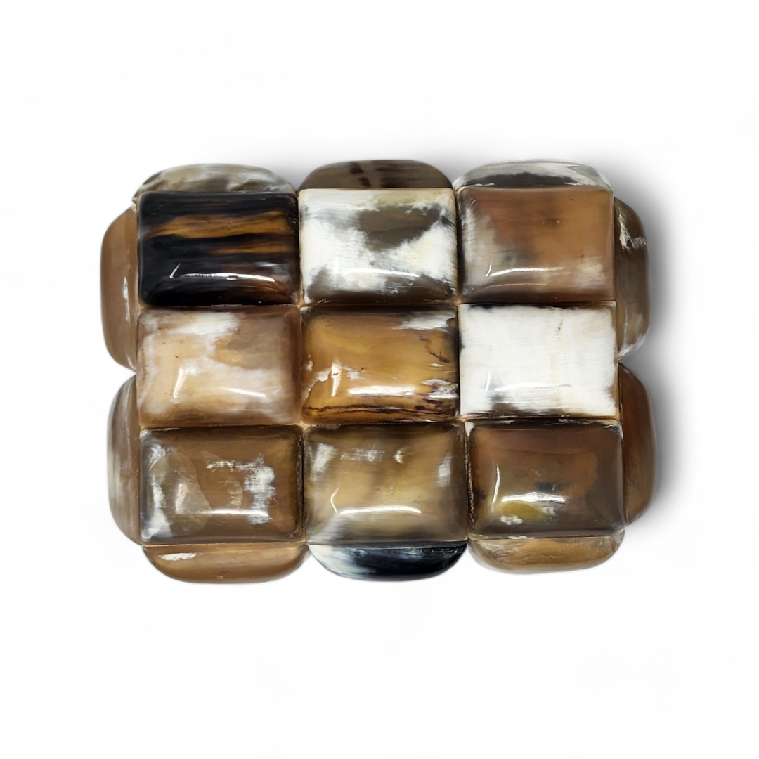 The Bubble Horn Box by A Sanoma Inc features large, glossy square beads in brown, beige, cream, and black arranged in a grid pattern—a unique piece perfect for whimsical decor or display on its own.