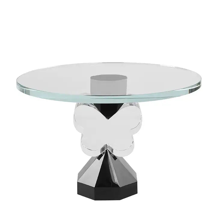 The Butterfly Cake Stand Clear & Black by Lainy Home is a limited edition piece featuring a clear butterfly central support and a sleek geometric black base.