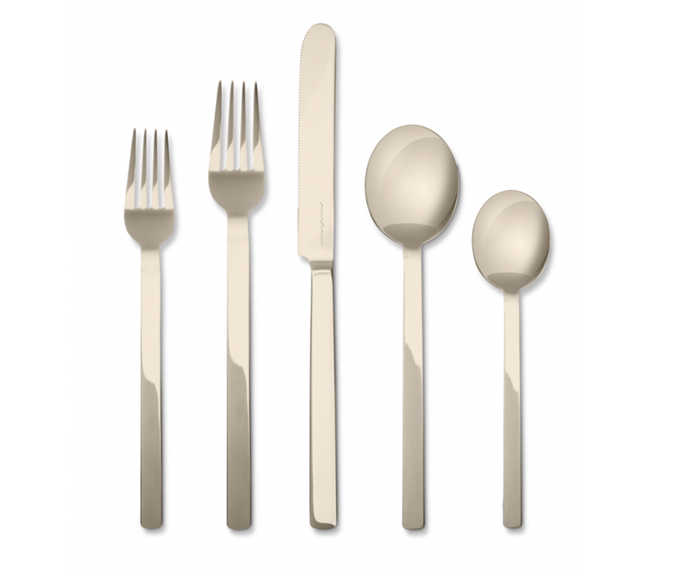 The Mepra Stile Flatware 5 Piece Setting - Peltro Champagne features two forks, a knife, a tablespoon, and a teaspoon with long, straight handles in an elegant modern champagne finish.