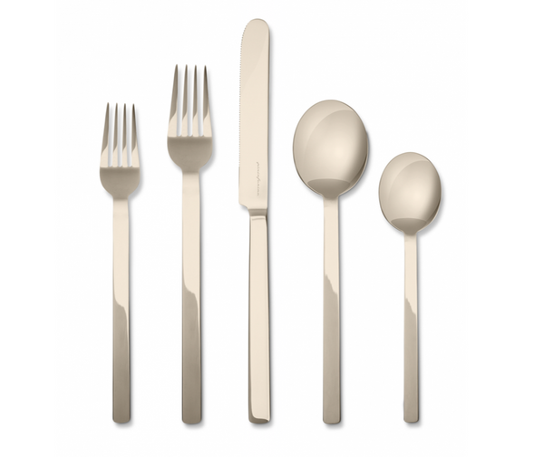 The Mepra Stile Flatware 5 Piece Setting - Peltro Champagne features two forks, a knife, a tablespoon, and a teaspoon with long, straight handles in an elegant modern champagne finish.