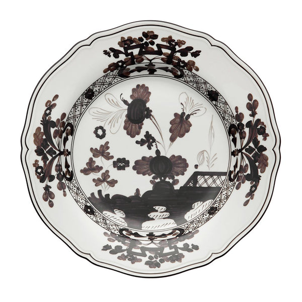 The Oriente Italiano Albus Dessert plate by Ginori 1735 features white porcelain with scalloped edges, adorned with detailed brown and black floral and foliage motifs on the rim and center.