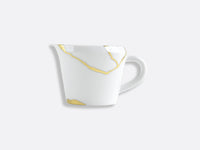 The Bernardaud Kintsugi Dinnerware white ceramic mug features gold-colored, irregular crack-like lines inspired by the Kintsugi art, highlighted against a plain light gray background and finished with a sleek handle.