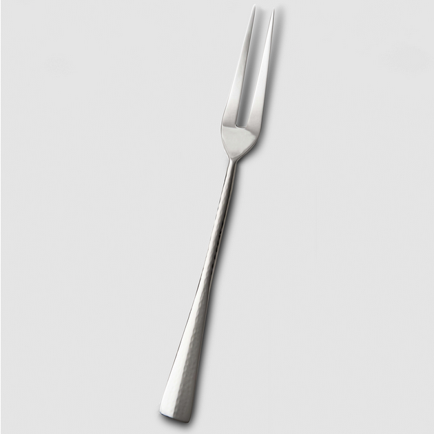 The Mary Jurek Alta Meat Serving Fork, crafted from stainless steel with two sharp prongs and a textured handle, is displayed on a plain light gray background—a sleek serveware addition.