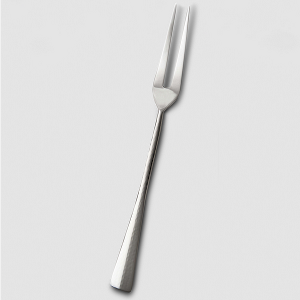The Mary Jurek Alta Meat Serving Fork, crafted from stainless steel with two sharp prongs and a textured handle, is displayed on a plain light gray background—a sleek serveware addition.