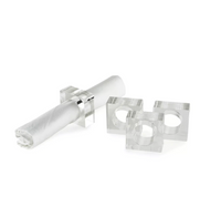 The Tizo Lucite Cube Napkin Ring Set of 4 features modern geometric designs with rectangular shapes and circular cutouts, making it a stylish choice for contemporary table decor.
