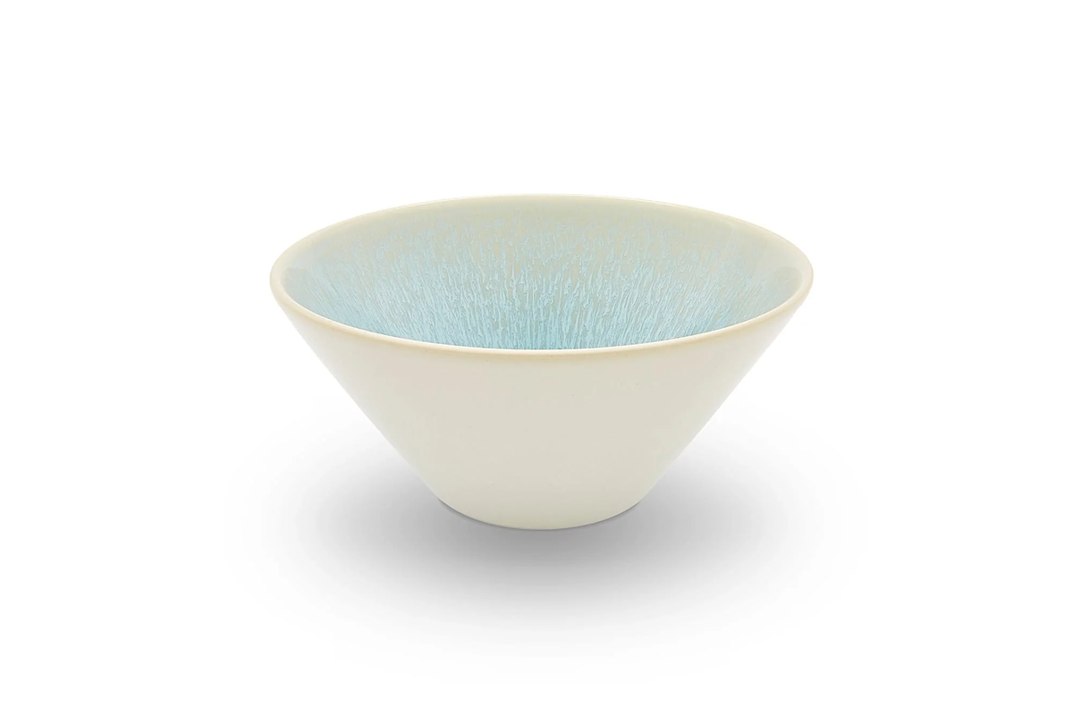 The Vuelta Atoll bowl by Jars - Rosenthal is a modern, white ceramic piece with a wide rim, matte finish, and light blue textured interior. Microwave safe, this stylish dinnerware is shown against a white background.