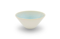 The Vuelta Atoll bowl by Jars - Rosenthal is a modern, white ceramic piece with a wide rim, matte finish, and light blue textured interior. Microwave safe, this stylish dinnerware is shown against a white background.