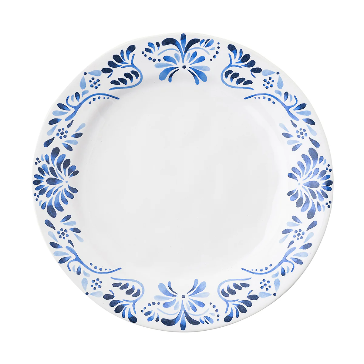 The Juliska Iberian Dinnerware features a round white dinner plate with a cobalt blue floral rim pattern inspired by Iberian Journey tiles; the center is plain and unadorned.