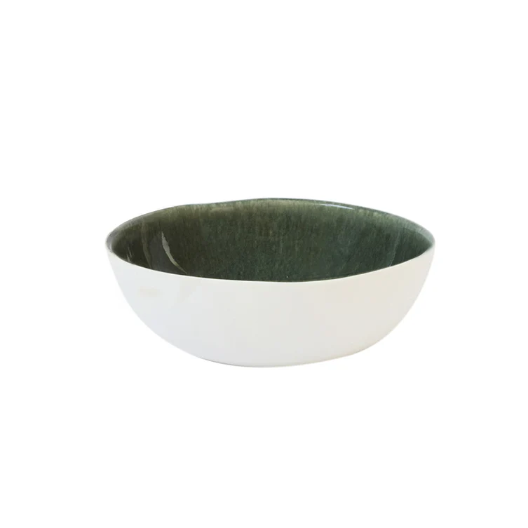The Maguelone Orage Dinnerware by Jars - Rosenthal is a round handcrafted stoneware bowl with a glossy white exterior and dark green interior, displayed against a plain white background.