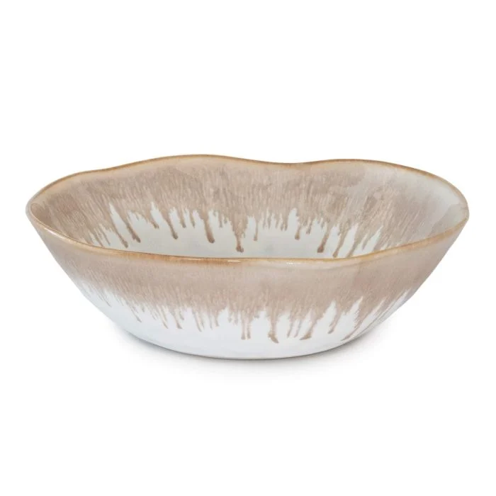 The Simon Pearce Burlington Dinnerware Bluff bowl features a wavy rim and brown-and-white drip glaze, offering an organic look reminiscent of classic Burlington dinnerware pottery.