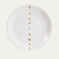 The Dibbern Golden Pearls Dinnerware Dessert Plate is crafted from white bone china and features a straight line of golden pearls down the center, graduating in size from top to bottom.