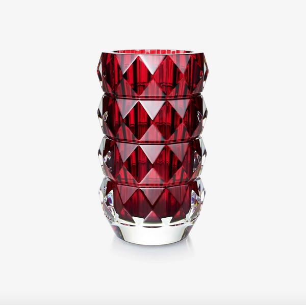 The Baccarat Louxor Round Vase Red features a geometric diamond-cut pattern with a deep red interior and clear exterior, reminiscent of the iconic Louxor design, displayed against a plain white background.