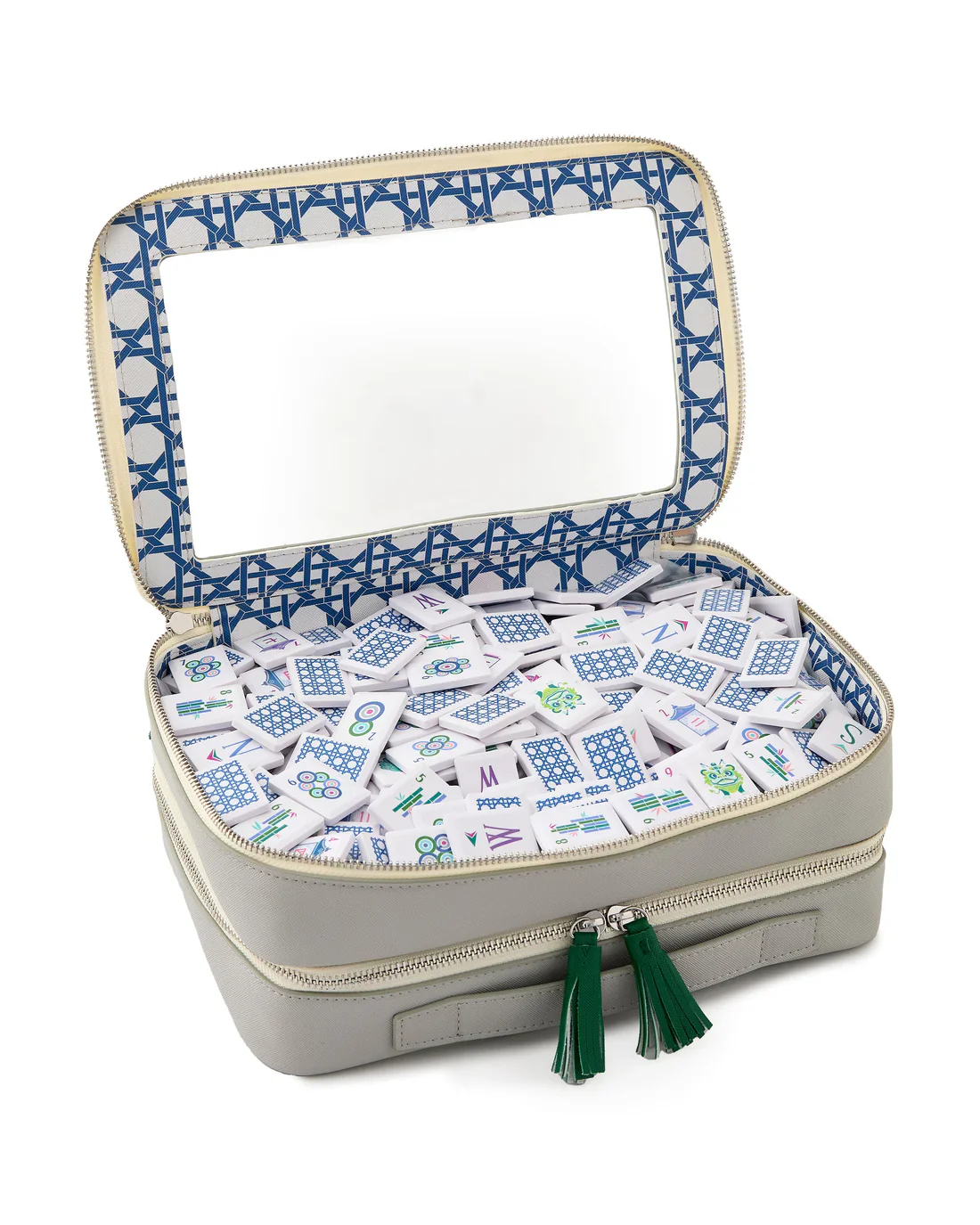 The Mahjong Debutante Travel Tile Set by Oh My Mahjong features a gray zippered case with green tassels, a large rectangular mirror in the lid, and blue patterned lining—perfect for travel or kids enjoying Mahjong on the go.