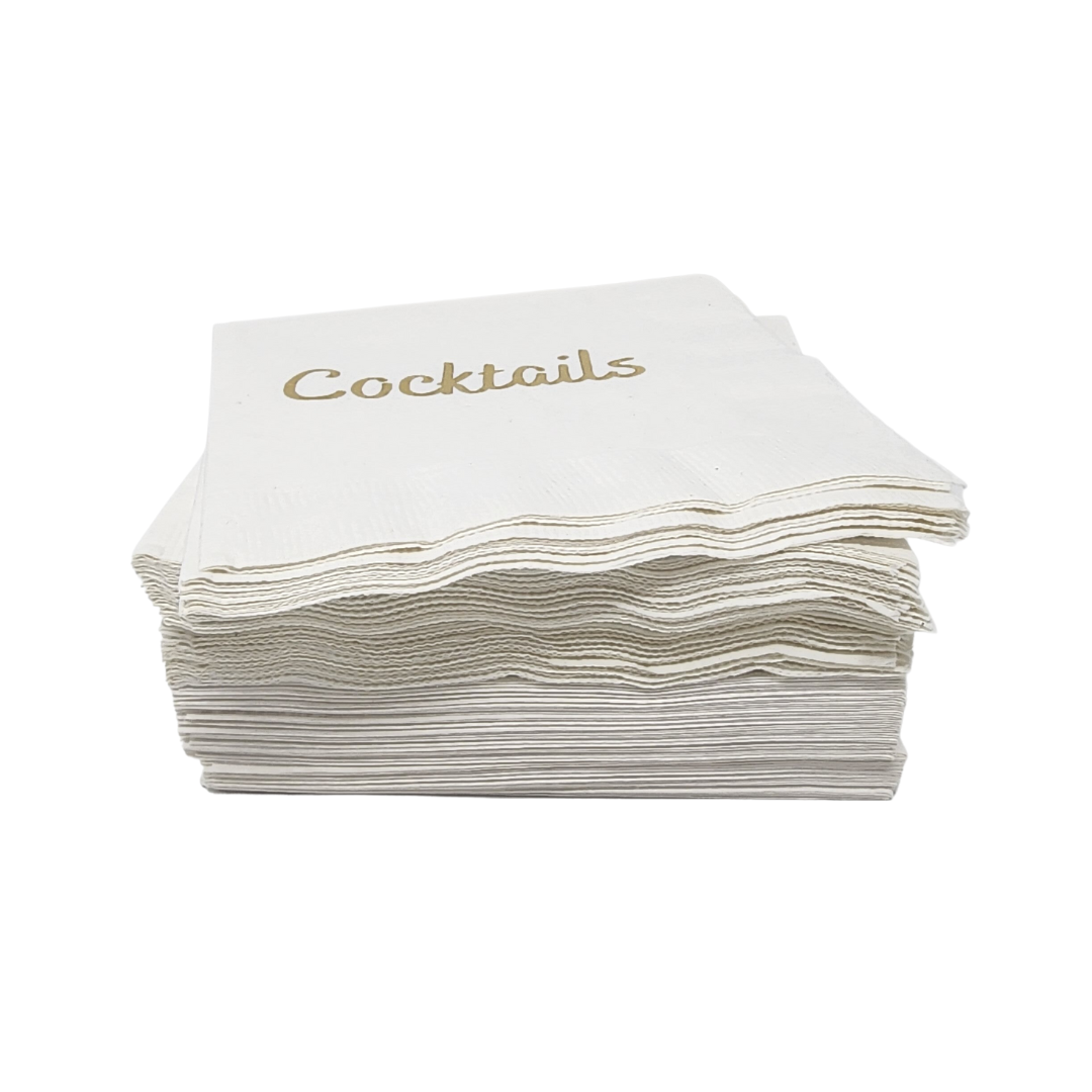 The Cocktails Napkin Pack - White & Gold by Print Appeal features elegant gold foil napkins with "Cocktails" in gold lettering on the top, displayed on a plain white background.