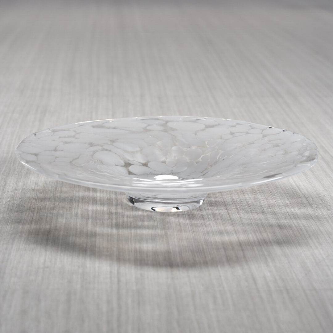 The Zodax Confetti Glass Bowl 14.25" features a shallow, clear hand-blown design with a wide rim and white marbled texture, displayed here on a light gray striped surface.