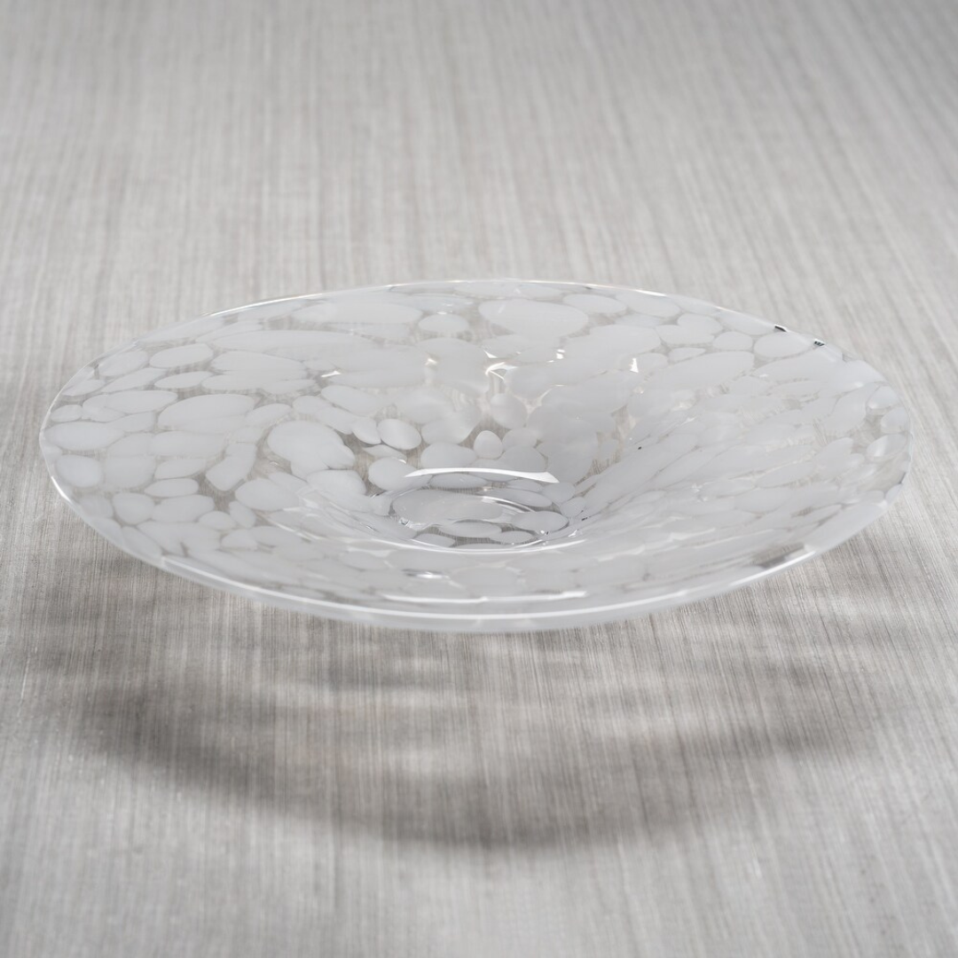 The Zodax Confetti Glass Bowl 14.25" is a food safe, hand-blown glass piece with a marbled white and clear pattern, wide rim, and a slight central depression, displayed on a light-colored textured surface.