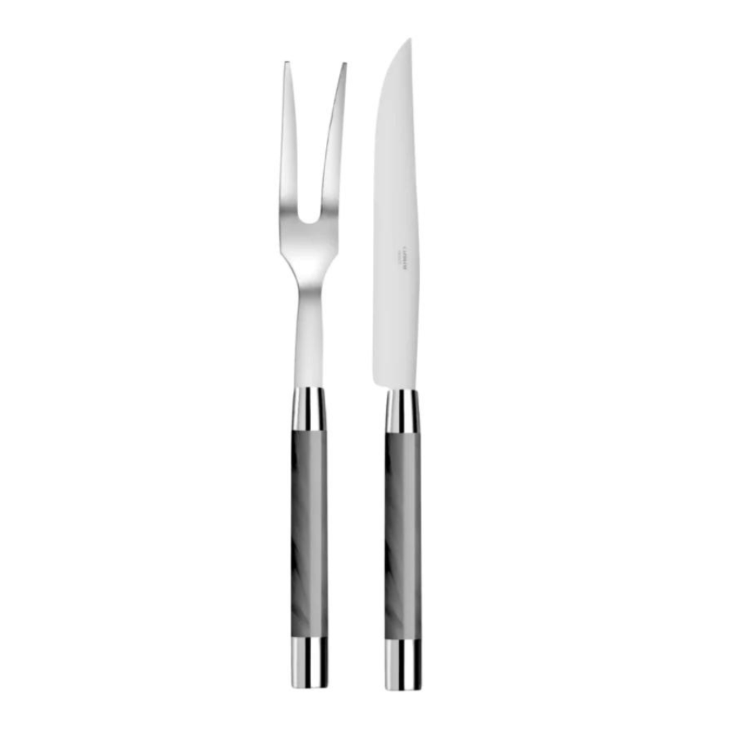 The Capdeco Conty Carne Carving Set Grey, made in France, features a stainless steel knife and fork with matching grey handles, both standing upright side by side on a white background.