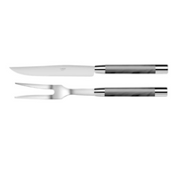 The Capdeco Conty Carne Carving Set Grey, crafted in France from premium 18/10 stainless steel, includes a carving knife and fork with grey handles, shown side by side on a white background.