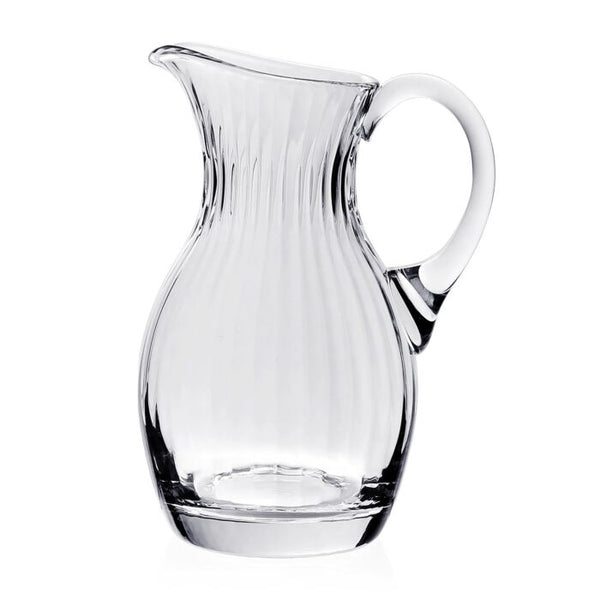 The William Yeoward Corinne Tall 3 Pint Pitcher features vertical ridges, a curved handle, and a wide spout. This clear handmade piece from the Corinne Collection is shown against a plain white background.