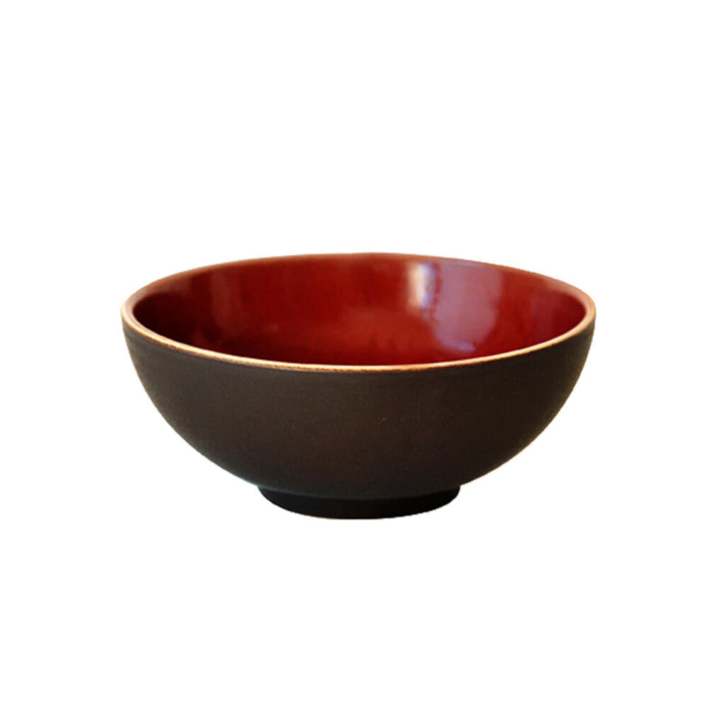 The Tourron Dinnerware Cerise by Jars - Rosenthal is a round ceramic bowl with a matte black exterior and glossy deep red interior, featuring elegant glazes and shown on a white background.