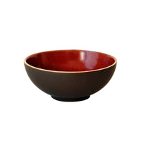 The Tourron Dinnerware Cerise by Jars - Rosenthal is a round ceramic bowl with a matte black exterior and glossy deep red interior, featuring elegant glazes and shown on a white background.
