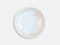A round white plate from Bernardaud’s Fèerie By Michael Cailloux collection features a gold, blue, and turquoise starburst border, displayed on a plain light gray background.