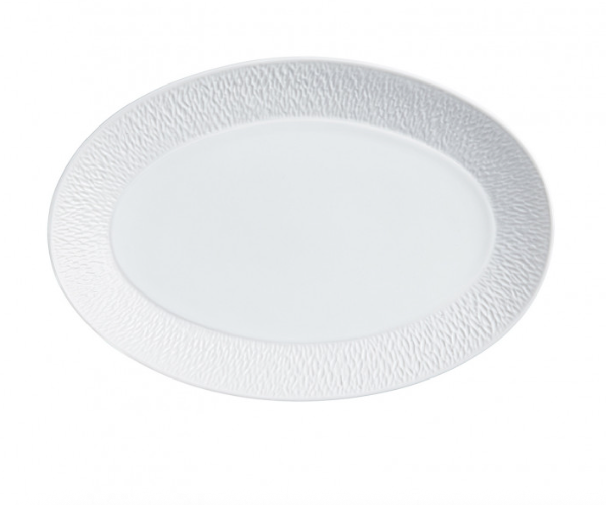 The Raynaud Mineral Dinnerware Glazed White oval plate is made from fine Limoges porcelain and features a subtle textured rim, shown against a white background.