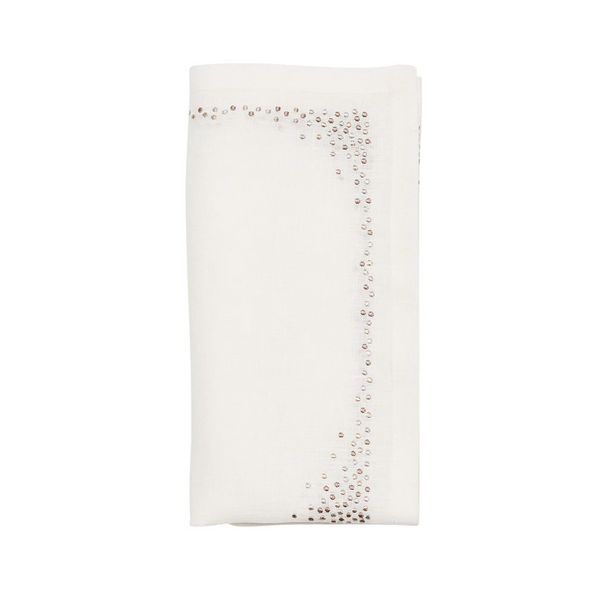 The Kim Seybert Pin Dot Napkin Set of 4 in white, natural, and gray features neatly folded linen napkins with scattered shiny sequin borders for an elegant look.