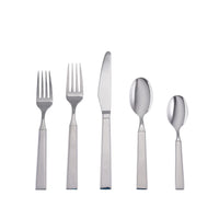 The Simon Pearce Woodstock 5 Piece Setting includes two forks, one knife, one tablespoon, and one teaspoon with square handles, shown upright on a white background in this elegant stainless steel flatware set.