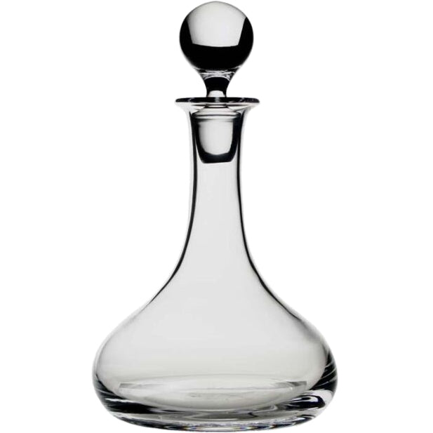 The William Yeoward Classic Ships Decanter is handmade from crystal glass, featuring a wide rounded base, slender neck, and round stopper, shown against a white background.