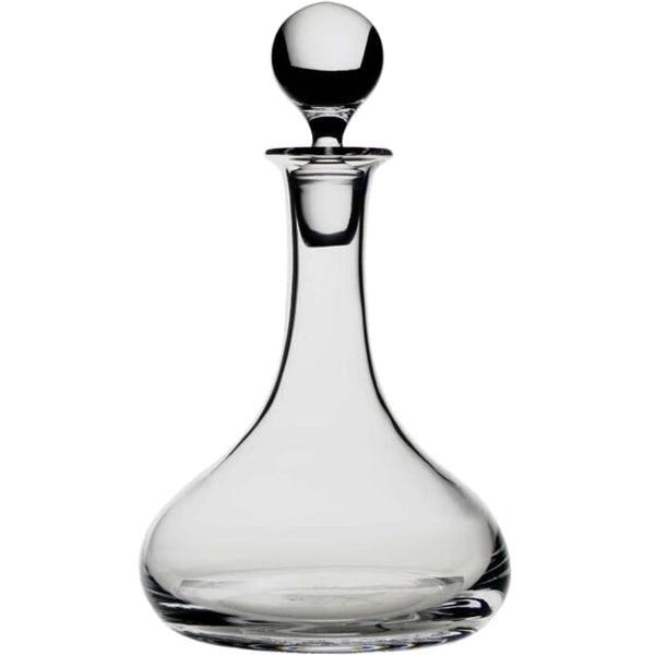 The William Yeoward Classic Ships Decanter is handmade from crystal glass, featuring a wide rounded base, slender neck, and round stopper, shown against a white background.