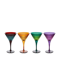 The Prism Martini Set of 4 by L’Objet features martini glasses in vibrant red, orange, green, and purple, each with fluted stems and radiating lines on hand-cut glass bowls—an eye-catching addition to any collection.