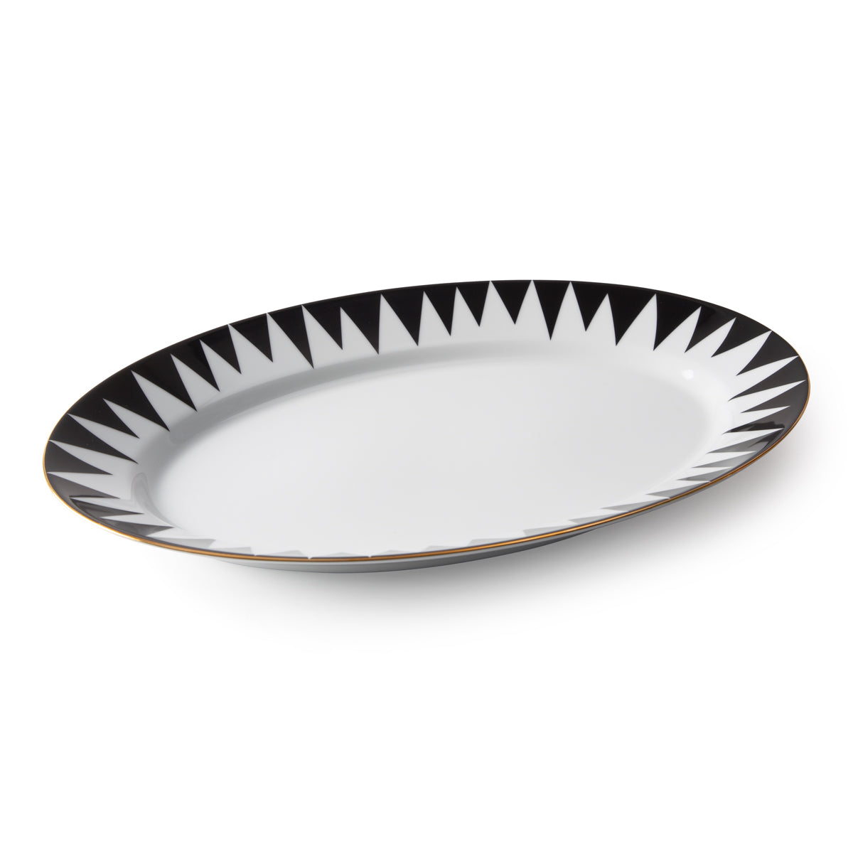 The Punk Dinnerware by Molecot is an oval white Limoges porcelain plate with bold black triangles and a thin gold rim, shown on a white background—a striking example of modern tableware.