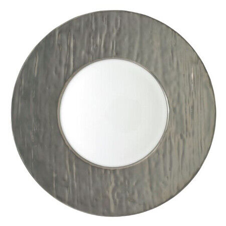 The Raynaud Makassar Metallic Charger features a wide, textured metallic gray rim and smooth white center, viewed from above against a white background, reflecting classic Makassar charger design.