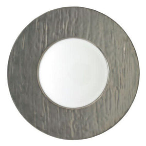 The Raynaud Makassar Metallic Charger features a wide, textured metallic gray rim and smooth white center, viewed from above against a white background, reflecting classic Makassar charger design.