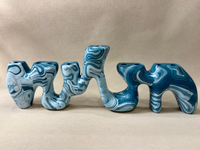 A Forma Menorah - Blue & White sculptural menorah featuring a fluid, abstract shape with a blue and white marbled pattern, embodying contemporary elegance.