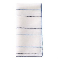 The Bodrum Porto Napkin Navy & Periwinkle Set of 4 features lightweight linen-blend napkins with thin blue grid lines on white, folded vertically for a classic look.