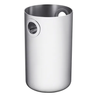 The Christofle Oh De Stainless Steel Wine Cooler features a sleek cylindrical design with two round cutout handles near the rim, making it perfect for elevating your home bar. Set against a plain light background.