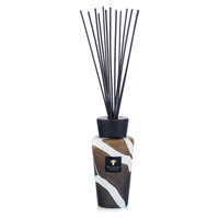 The Baobab Stones Diffuser - Agate is a decorative home fragrance diffuser, featuring a patterned brown and white Agate glass bottle, a sleek black cap, and several long black reeds standing upright.