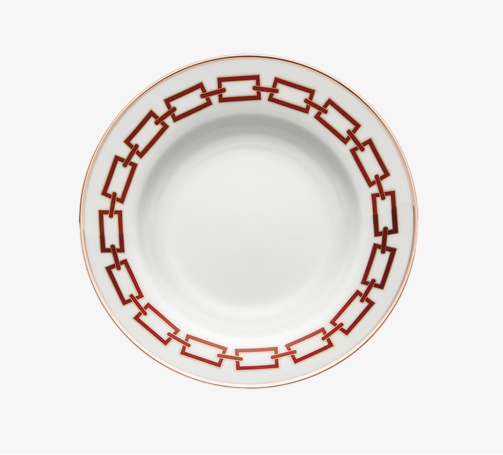 The Catene Scarlatto Dinnerware by Ginori 1735 features a bold red and gold geometric chain-link rim, inspired by Gio Ponti, on elegant white porcelain with a plain center.