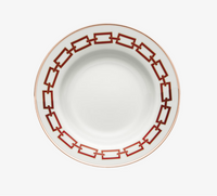 The Catene Scarlatto Dinnerware by Ginori 1735 features a bold red and gold geometric chain-link rim, inspired by Gio Ponti, on elegant white porcelain with a plain center.