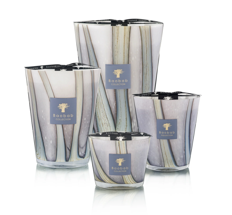 Four decorative Baobab candles, including the Woods Broceliande Candle inspired by Brittany’s mystical Brocéliande forest, displayed in glass holders featuring abstract vertical designs against a white background.
