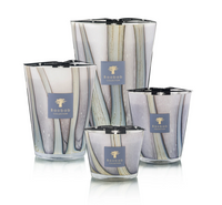 Four decorative Baobab candles, including the Woods Broceliande Candle inspired by Brittany’s mystical Brocéliande forest, displayed in glass holders featuring abstract vertical designs against a white background.