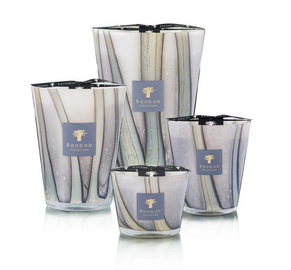 Four decorative Baobab candles, including the Woods Broceliande Candle inspired by Brittany’s mystical Brocéliande forest, displayed in glass holders featuring abstract vertical designs against a white background.
