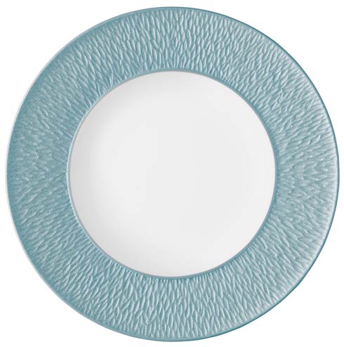 The Raynaud Mineral Irise Dinnerware Sky Blue plate is a round ceramic piece made in France, featuring a textured blue-green rim and smooth white center, shown from above on a white background.