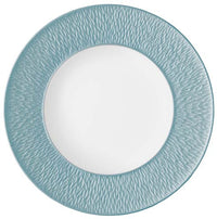 The Raynaud Mineral Irise Dinnerware Sky Blue plate is a round ceramic piece made in France, featuring a textured blue-green rim and smooth white center, shown from above on a white background.