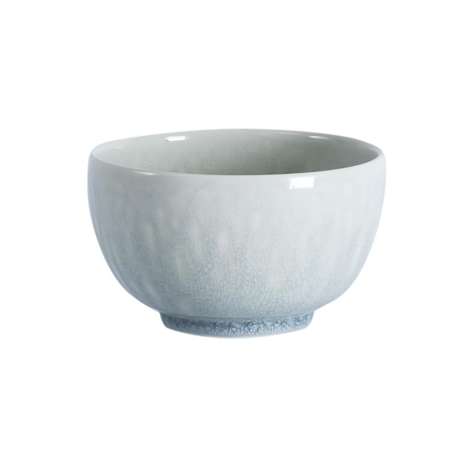 A pale blue, round Jars - Rosenthal Tourron Dinnerware - Opale stoneware bowl with a subtle crackled glaze finish.