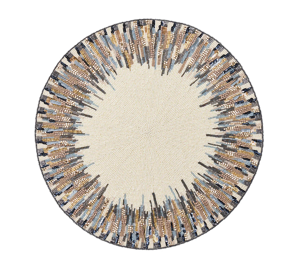 The Diadem Placemat Set of 2 by Kim Seybert features a cream center with a gold, brown, black, and blue sunburst beaded design—an elegant accent to elevate any dining setting.