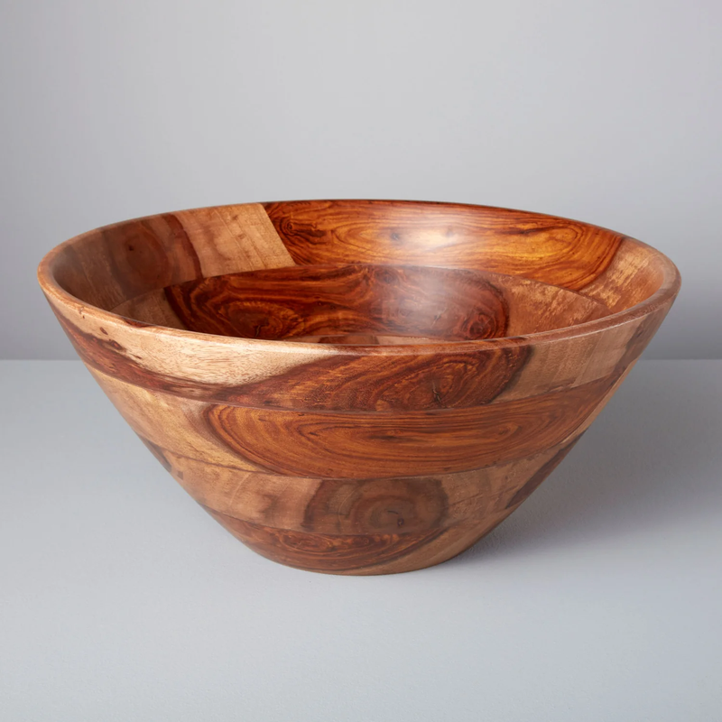 The Bumi Rosewood Serving Bowl by Be Home features a large, round shape with striking natural wood grain, handcrafted and displayed on a light gray surface with a pale gray background.