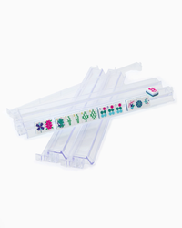 The Oh My Mahjong Rack & Pusher Set - Clear includes four transparent racks, each holding assorted floral, bamboo, and character tiles. Perfect accessories for organizing your American Mahjong game.